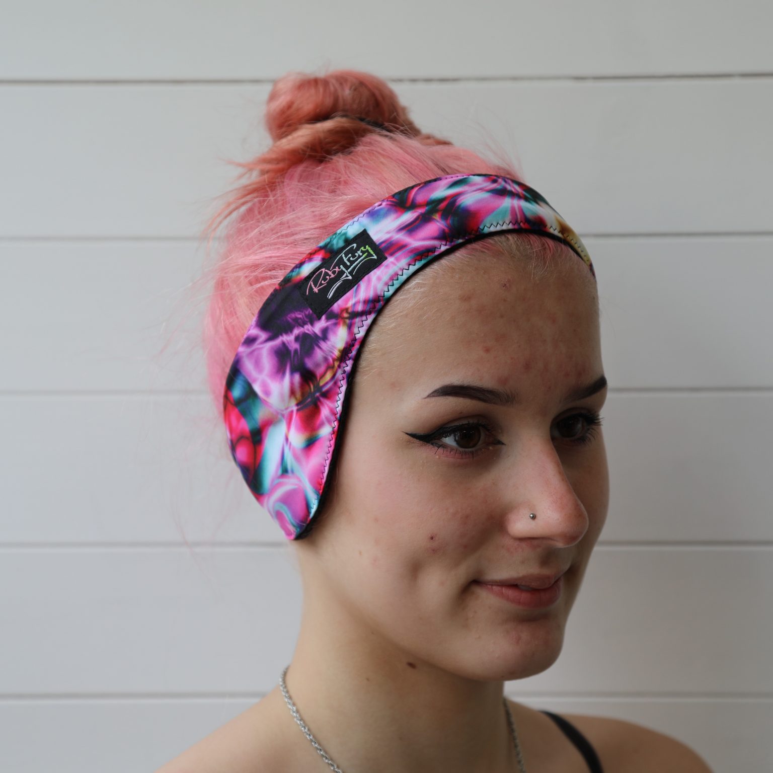 pink refraction fleece headband worn by model